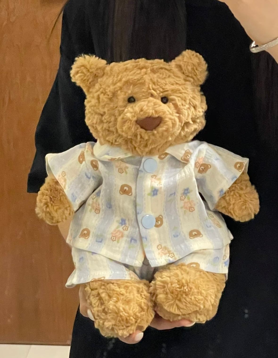 Bartholomew Bear wearing blue gingham bear print pyjama set, back view
