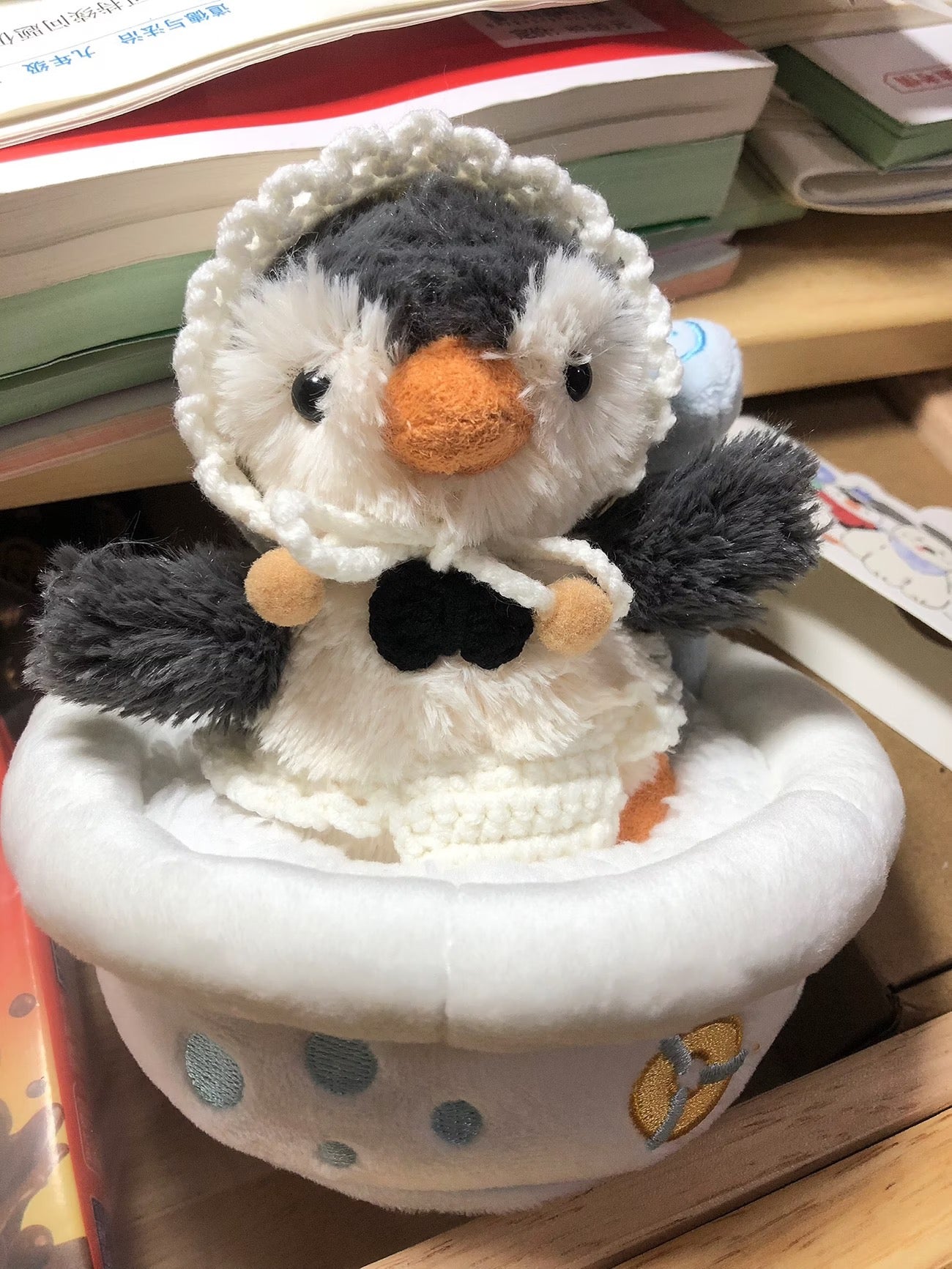 Peanut Penguin sitting inside plush duck bath tub prop