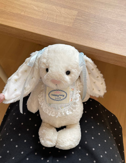 White plush bunny wearing Happy Day Luck lace bib - seated view