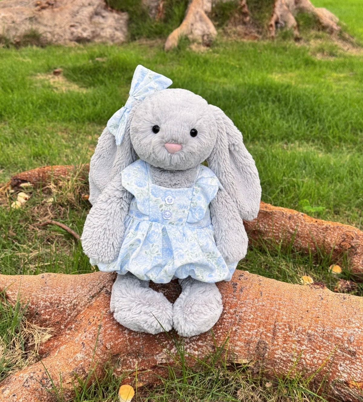 Plush bear, bunny and pig wearing floral dresses and matching bows in three colourways