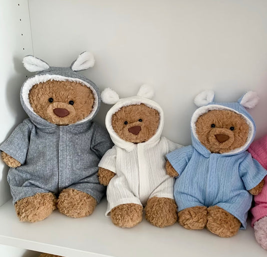 Teddy bear in a baby blue bunny-ear hooded romper