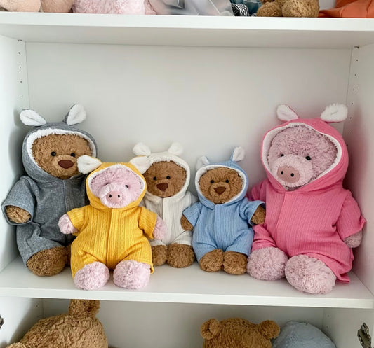 Teddy bear in a cream textured bunny-ear hooded romper