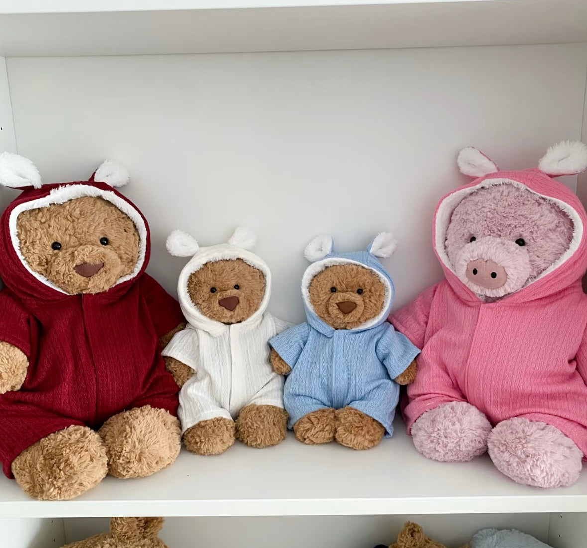 Plush pig in a yellow bunny-ear hooded romper