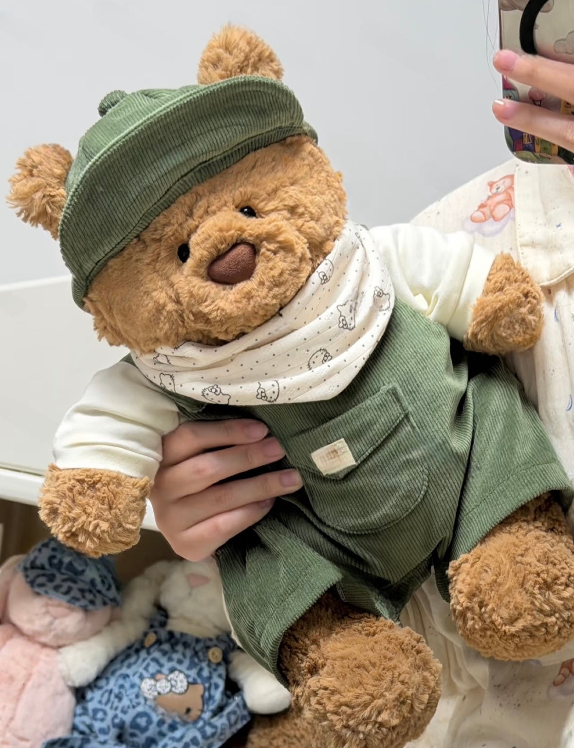 Bartholomew Bear wearing a beige corduroy outfit with matching cap and printed bandana