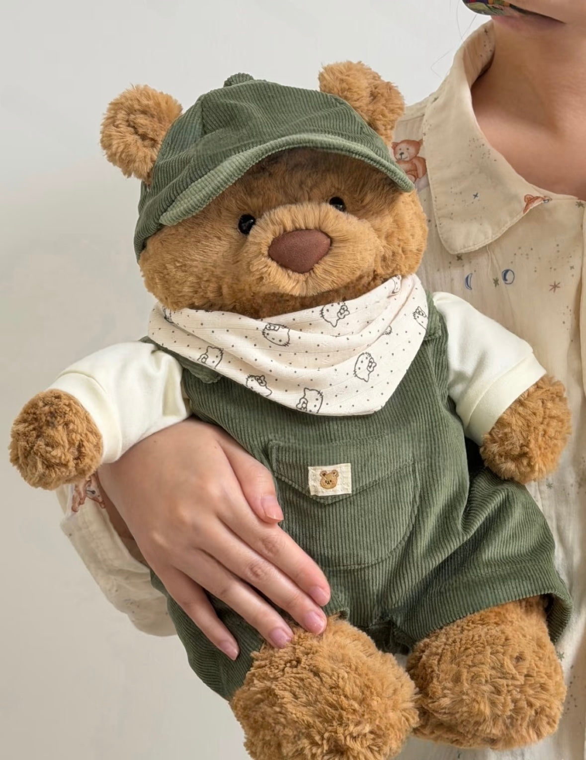 Bartholomew Bear wearing a yellow corduroy outfit with matching cap and printed bandana