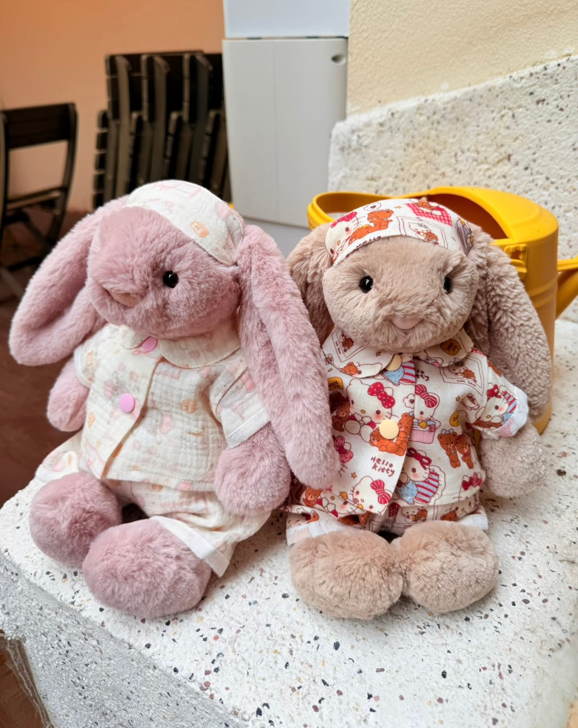 Pink bunny wearing pastel top, bottoms and cap beside an open window