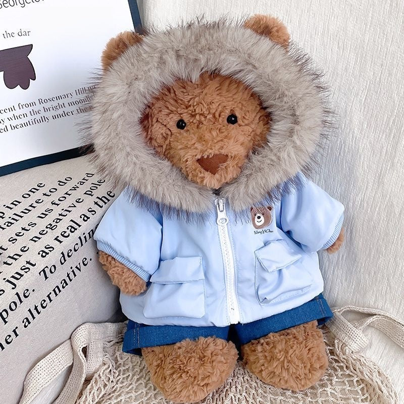 Bartholomew Bear wearing a khaki green fur-hood parka and denim shorts