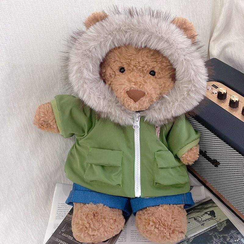 Bartholomew Bear wearing a butter yellow fur-hood parka and denim shorts