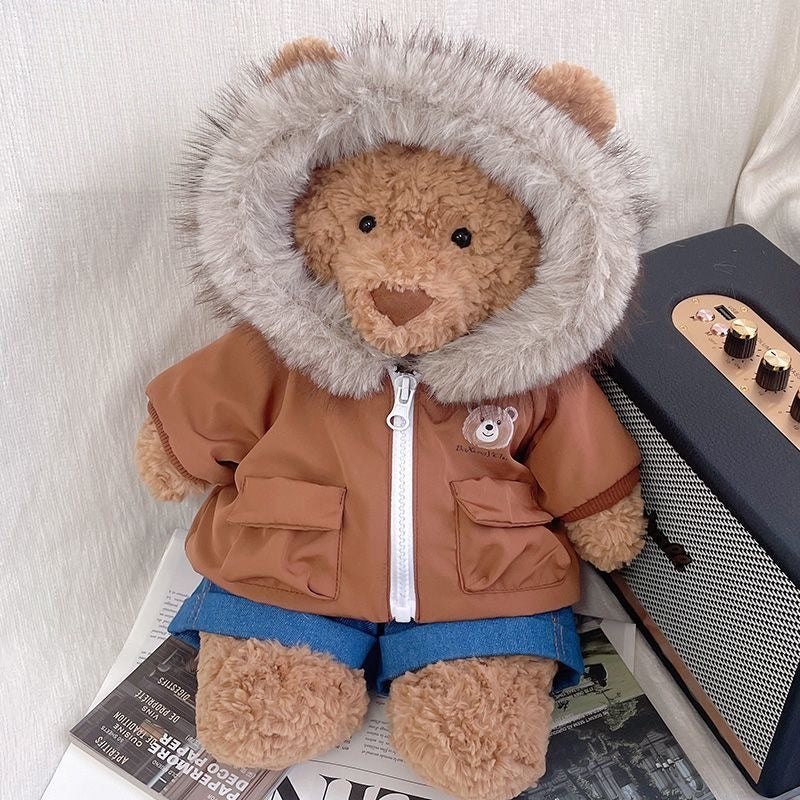 Bartholomew Bear wearing a lilac fur-hood parka and denim shorts