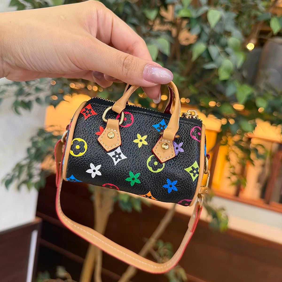 Mini dark bucket bag with brown motifs and tan trim