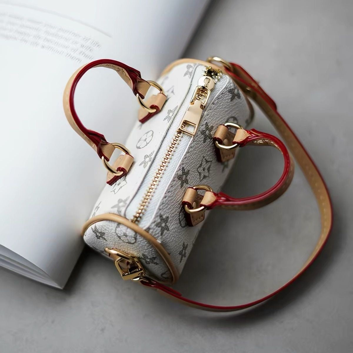Top view of a white and grey patterned mini handbag showing its zip and handles