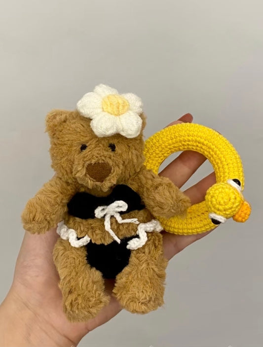 Bartholomew Bear in black crochet bikini with daisy headpiece and yellow duck ring float