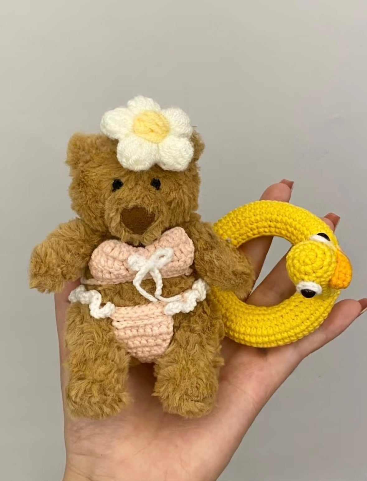 Bartholomew Bear in pink crochet bikini with daisy headpiece and yellow duck ring float