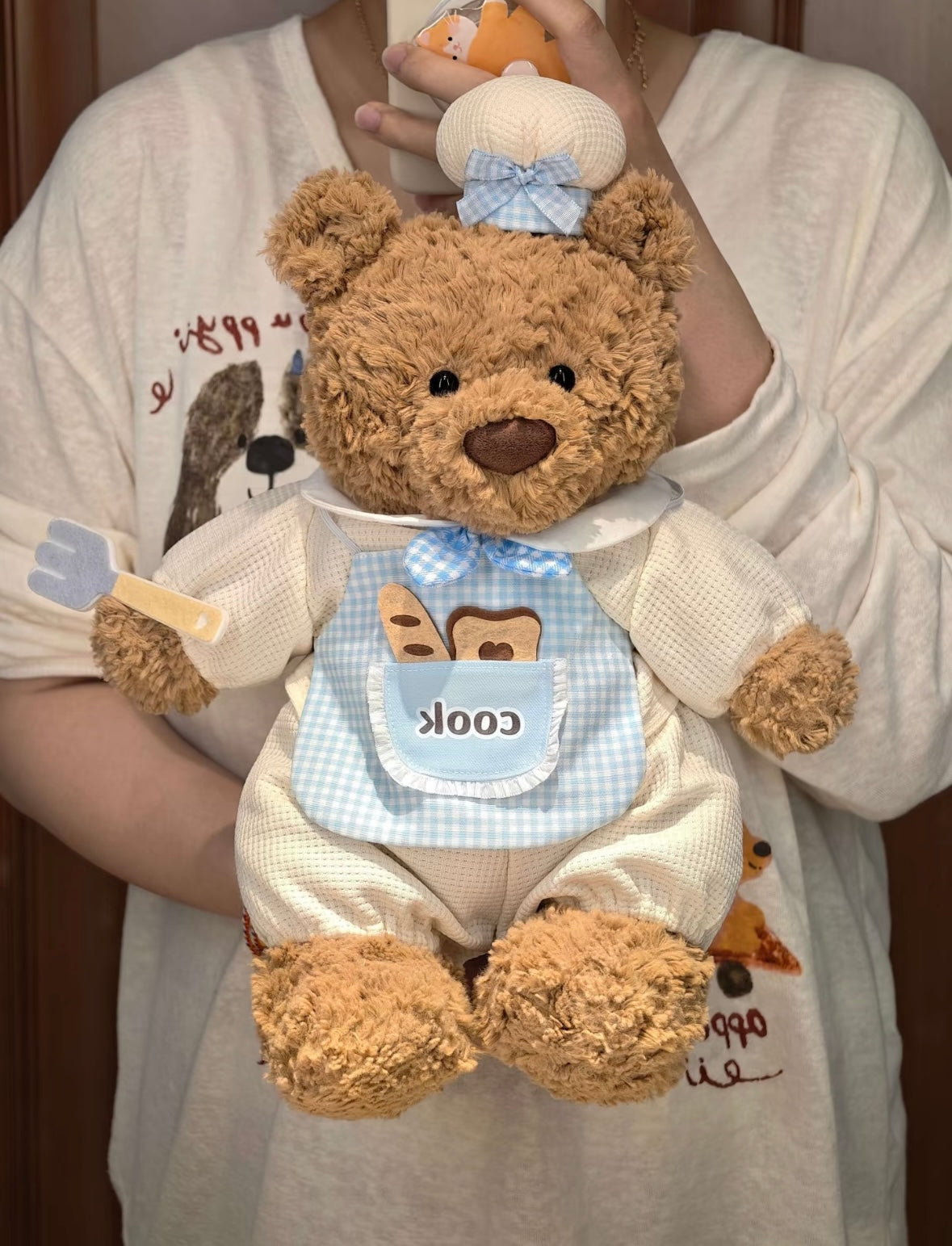 Bartholomew Bear wearing pink Little Chef romper set with chef hat and fork