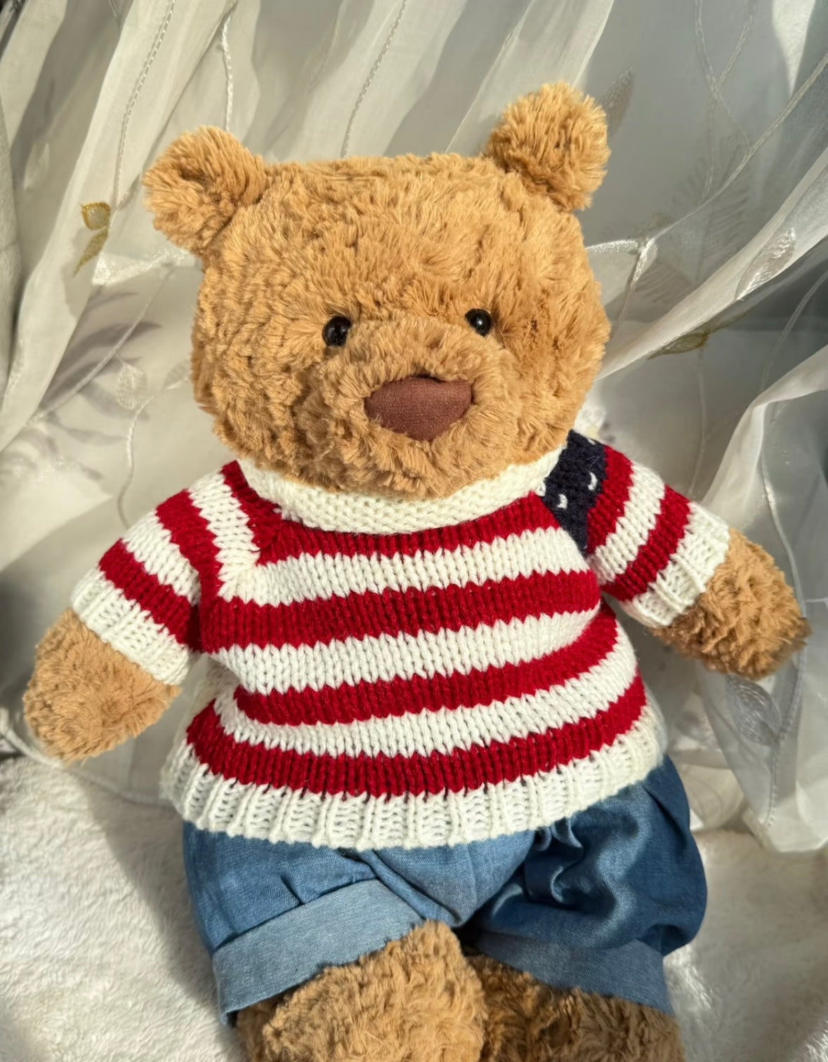 Two Bartholomew Bears wearing red and white striped knit sweaters with denim shorts and grey trousers