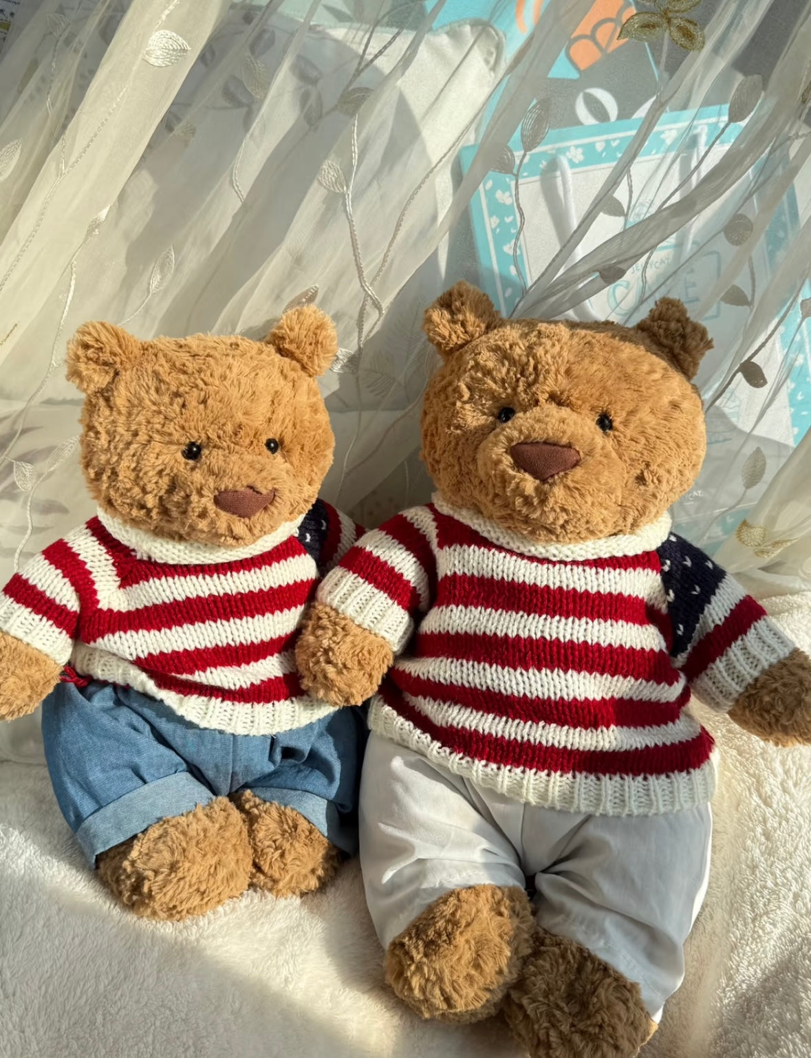 Bartholomew Bear wearing red and white striped knit sweater with denim shorts