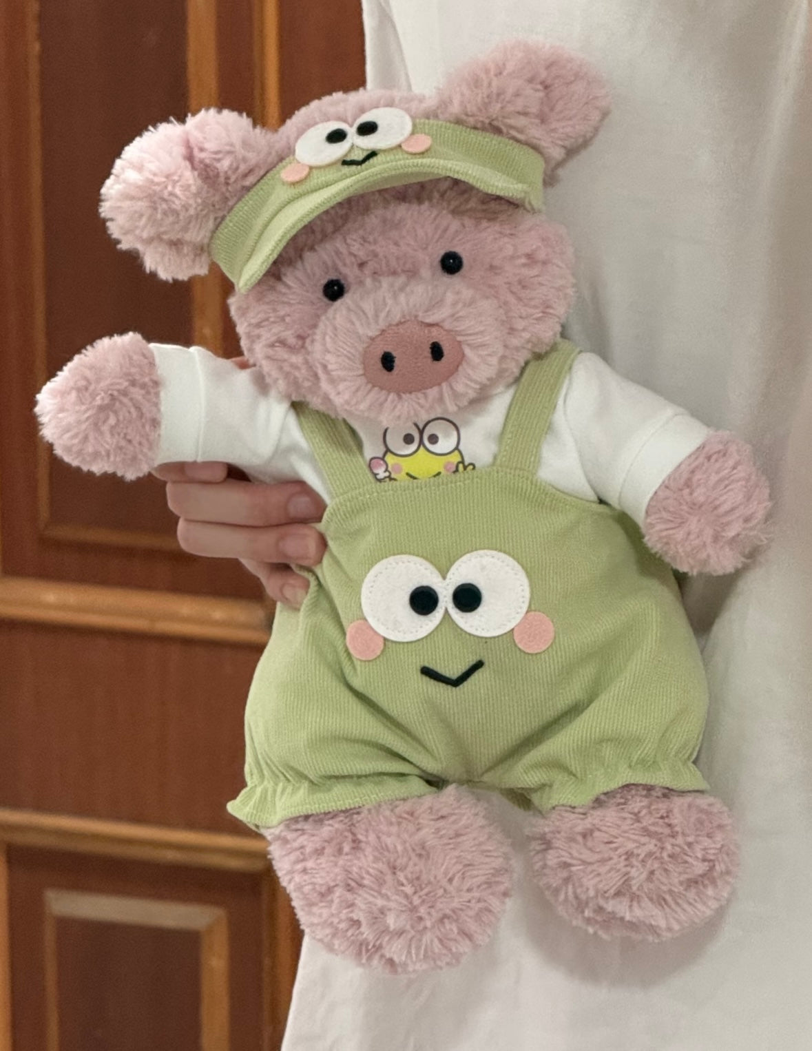 Pink pig plush wearing frog dungaree set - side view