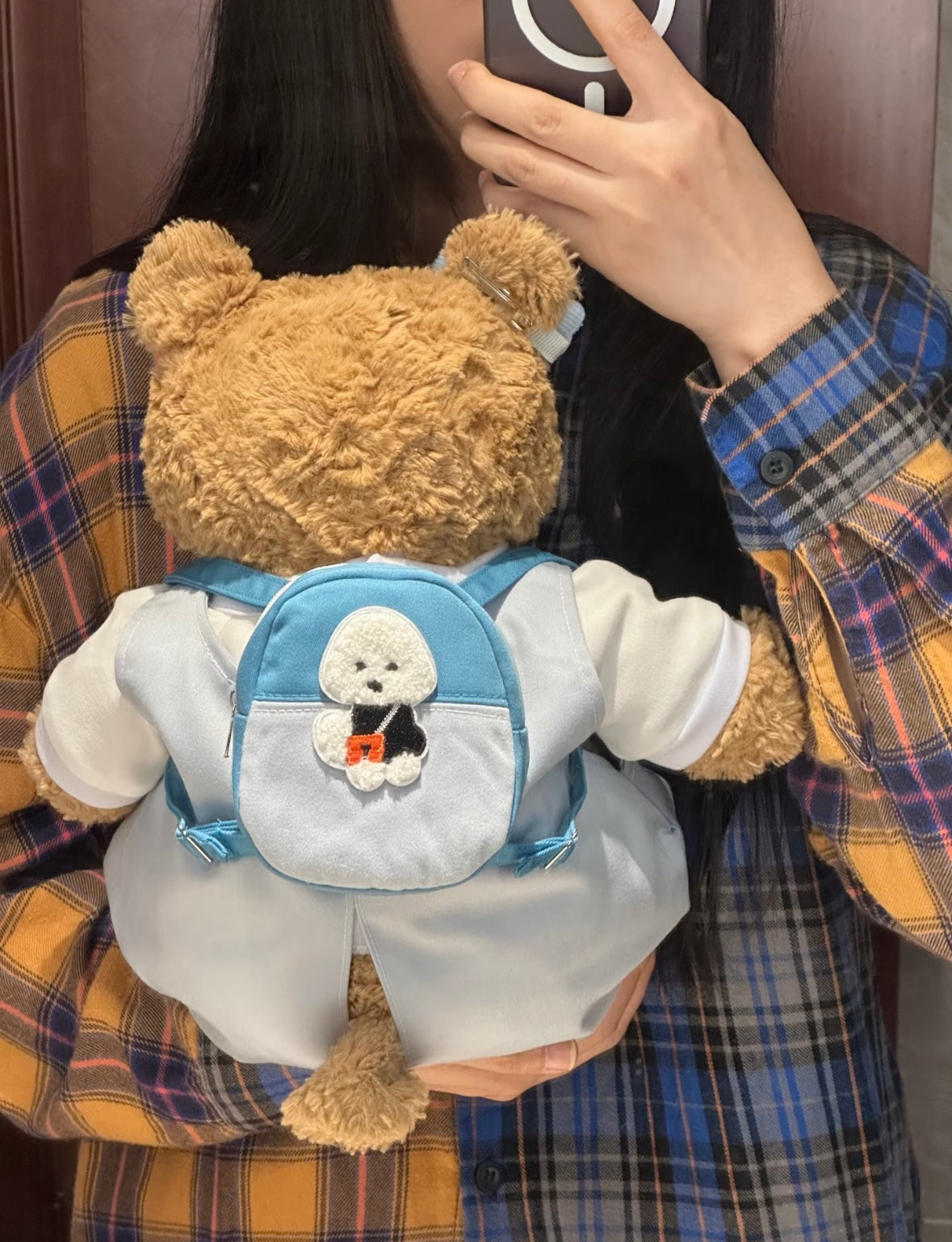 Bartholomew Bear wearing baby blue Snoopy dungaree set, front view