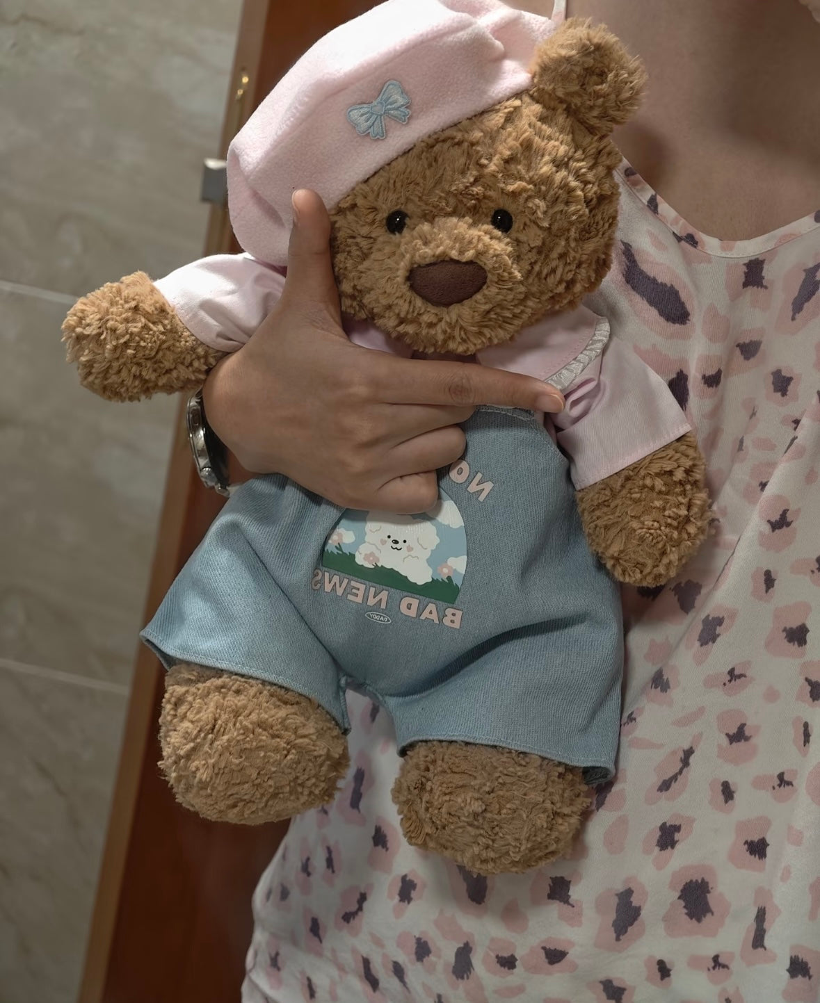 Bartholomew Bear wearing No More Bad News dungaree set - held view