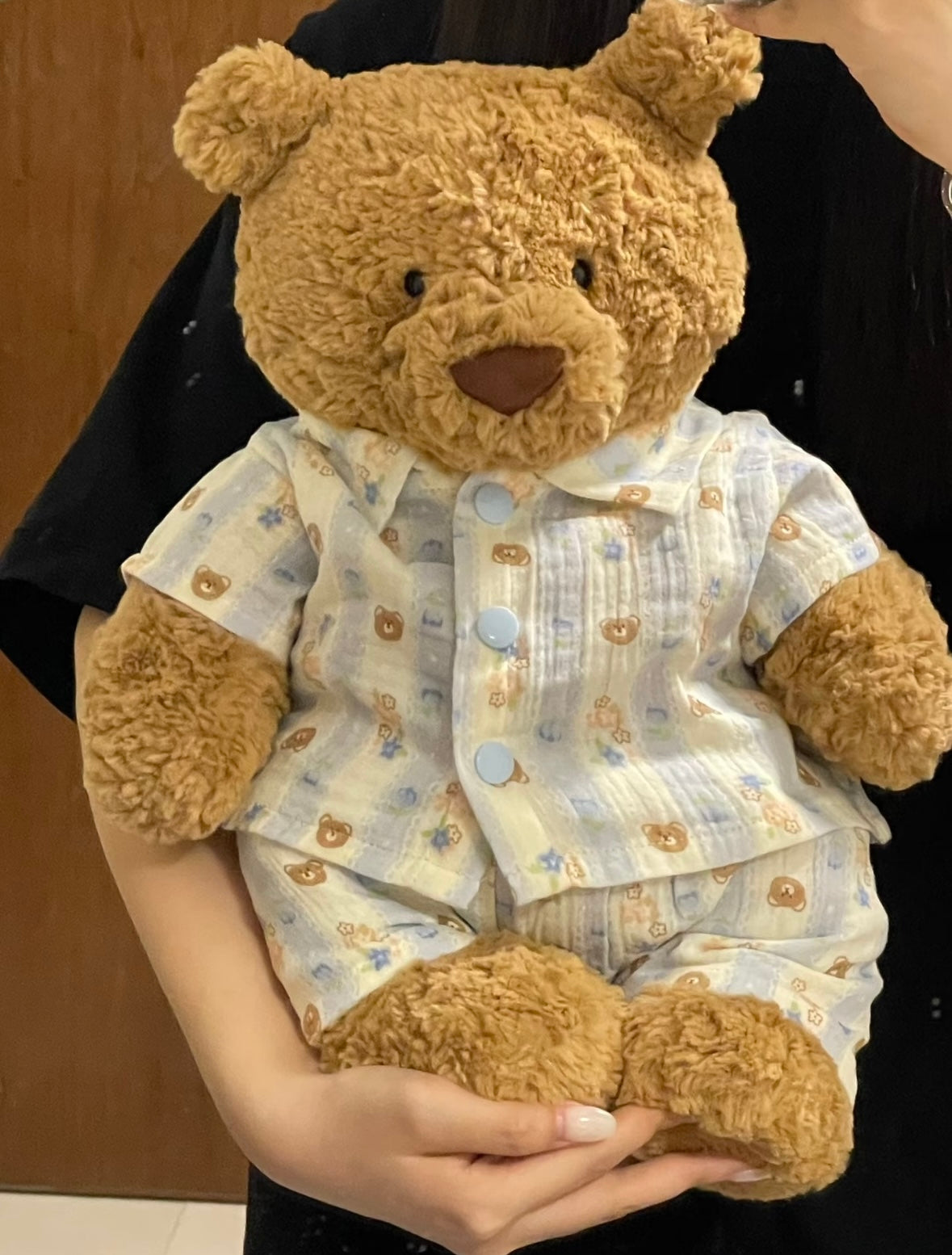 Bartholomew Bear wearing blue gingham bear print pyjama set, front view