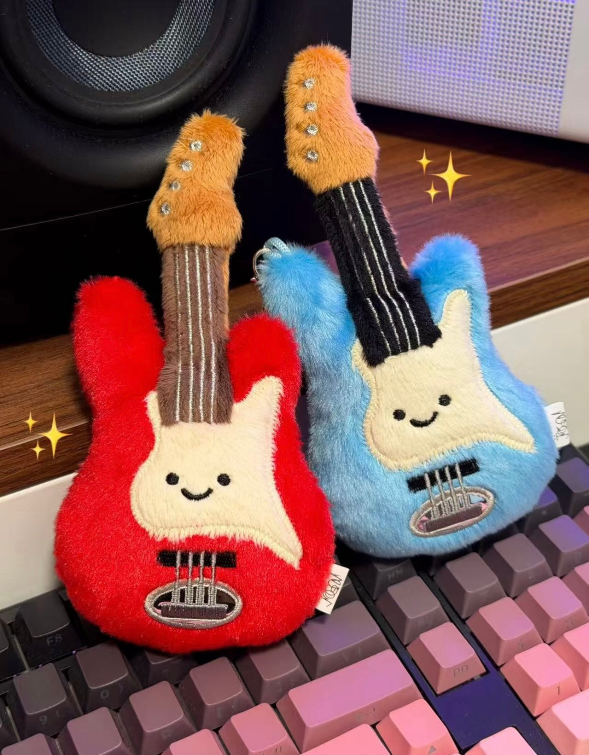 Bashful Bunny holding red electric guitar charm
