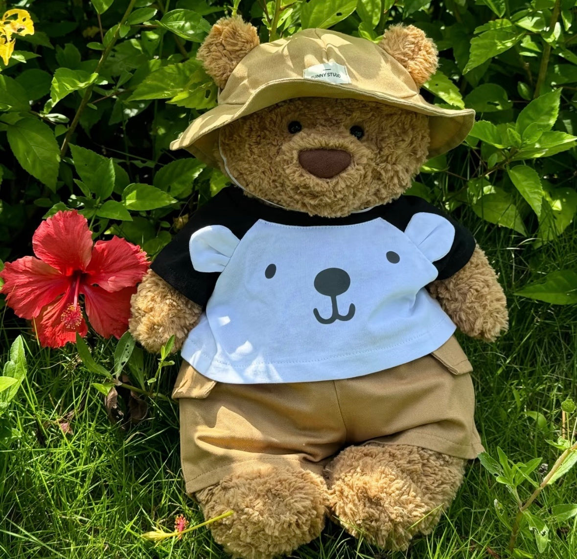 Bartholomew Bear wearing summer explorer set with bucket hat outdoors
