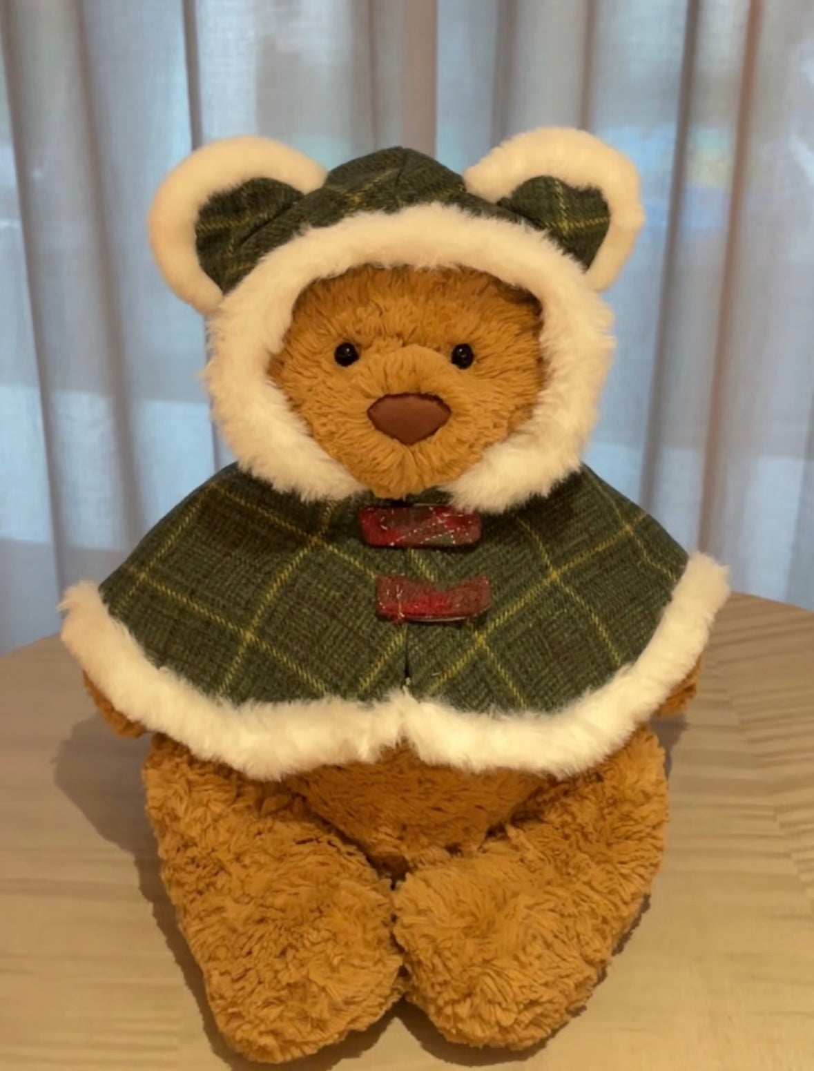 Bartholomew Bear wearing forest green tartan tweed cape with sherpa trim and bear ear hood