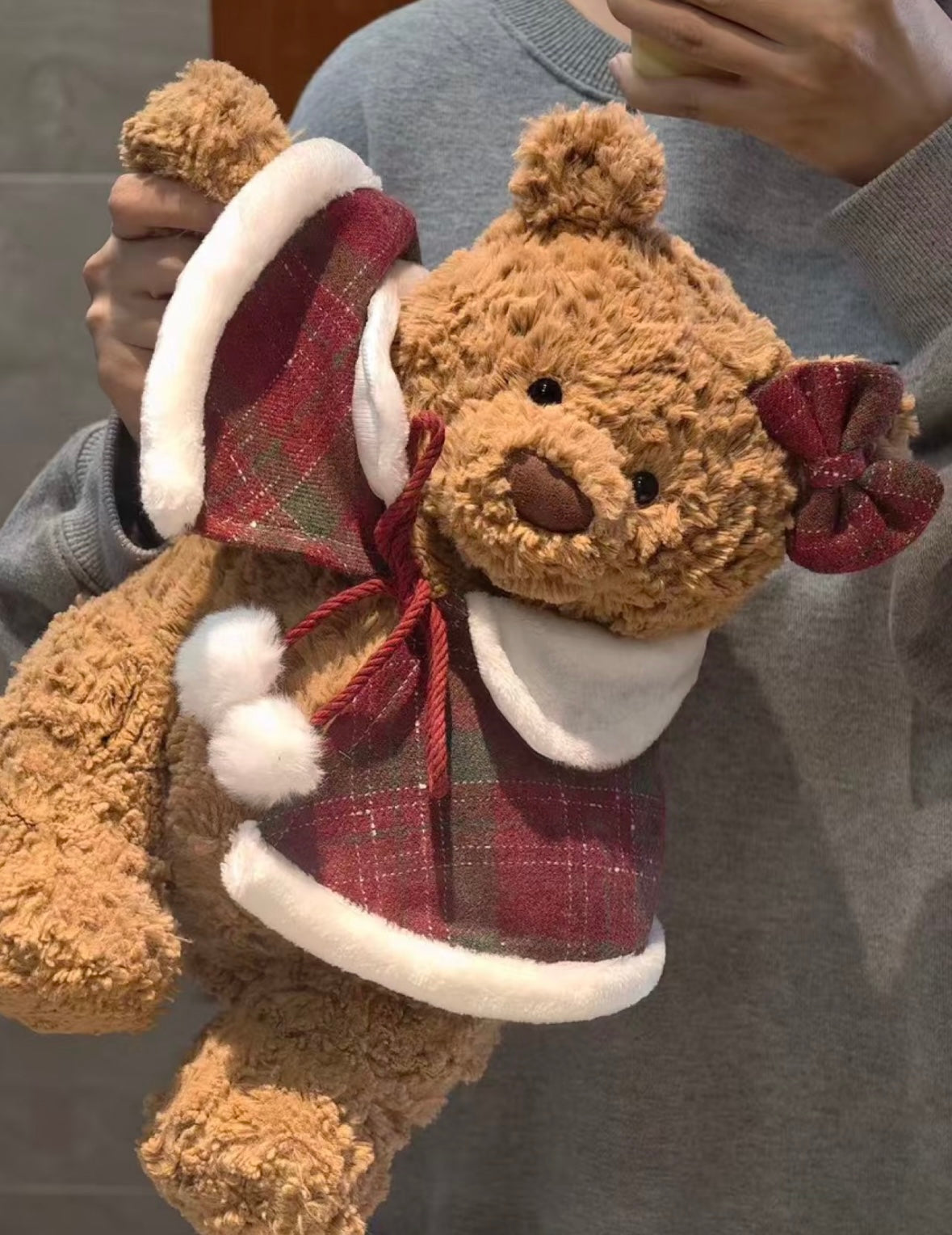Bartholomew Bear wearing festive red tartan mini cape with Santa hat and pom-pom ties