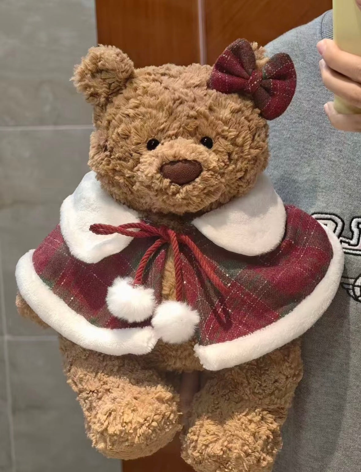 Bartholomew Bear wearing festive red tartan mini cape with red bow clip