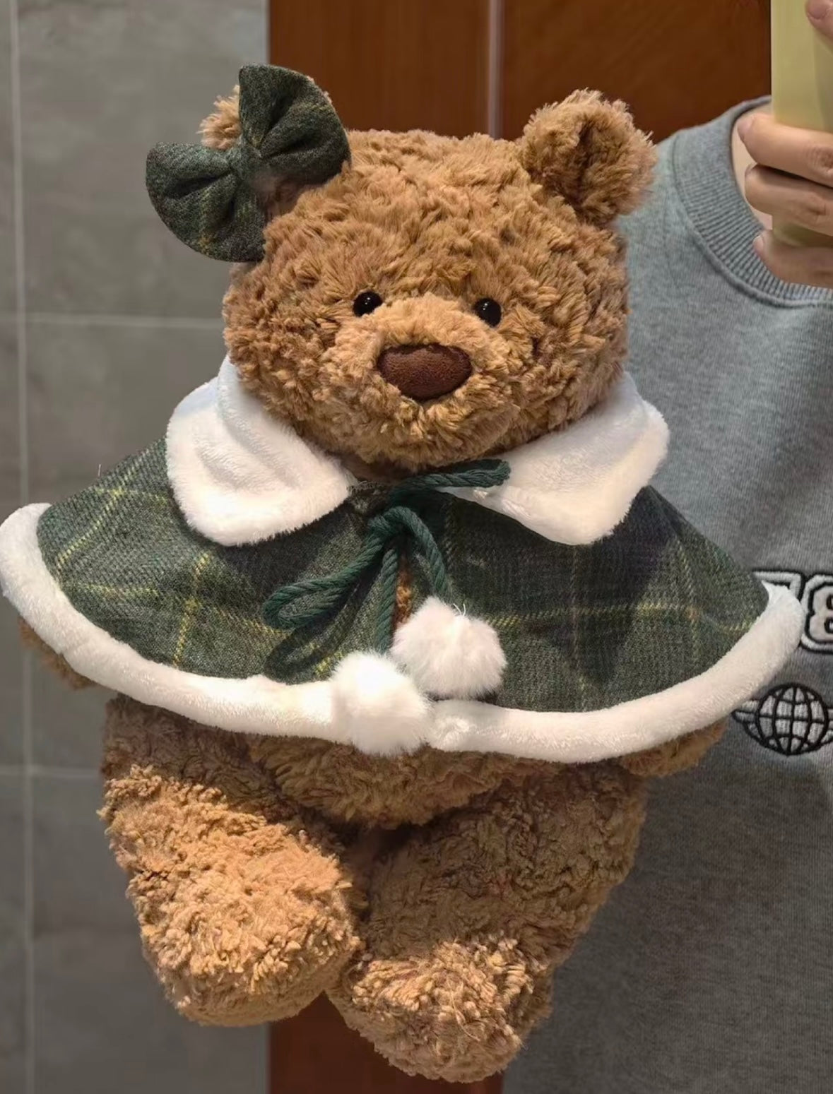 Bartholomew Bear wearing forest green tartan mini cape with green bow clip