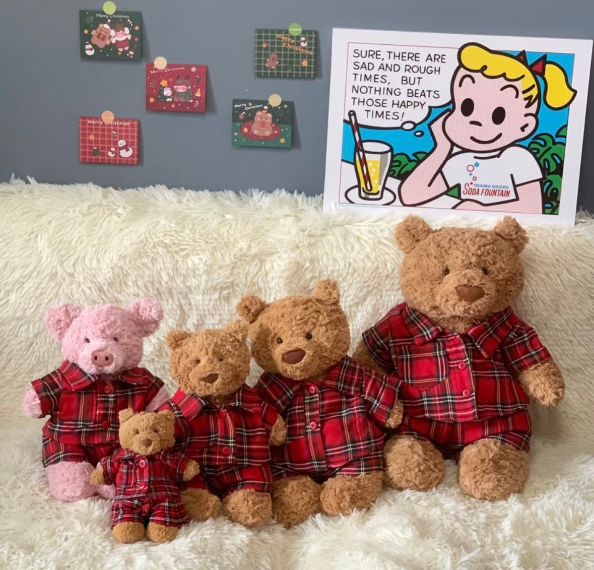 Jellycat plush toys wearing red tartan pyjama sets on fluffy rug