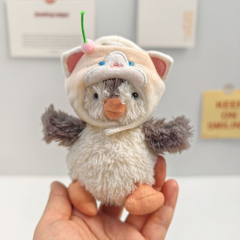 Jellycat Peanut Penguin wearing cream cat hoodie hat with embroidered ears and cherry stem
