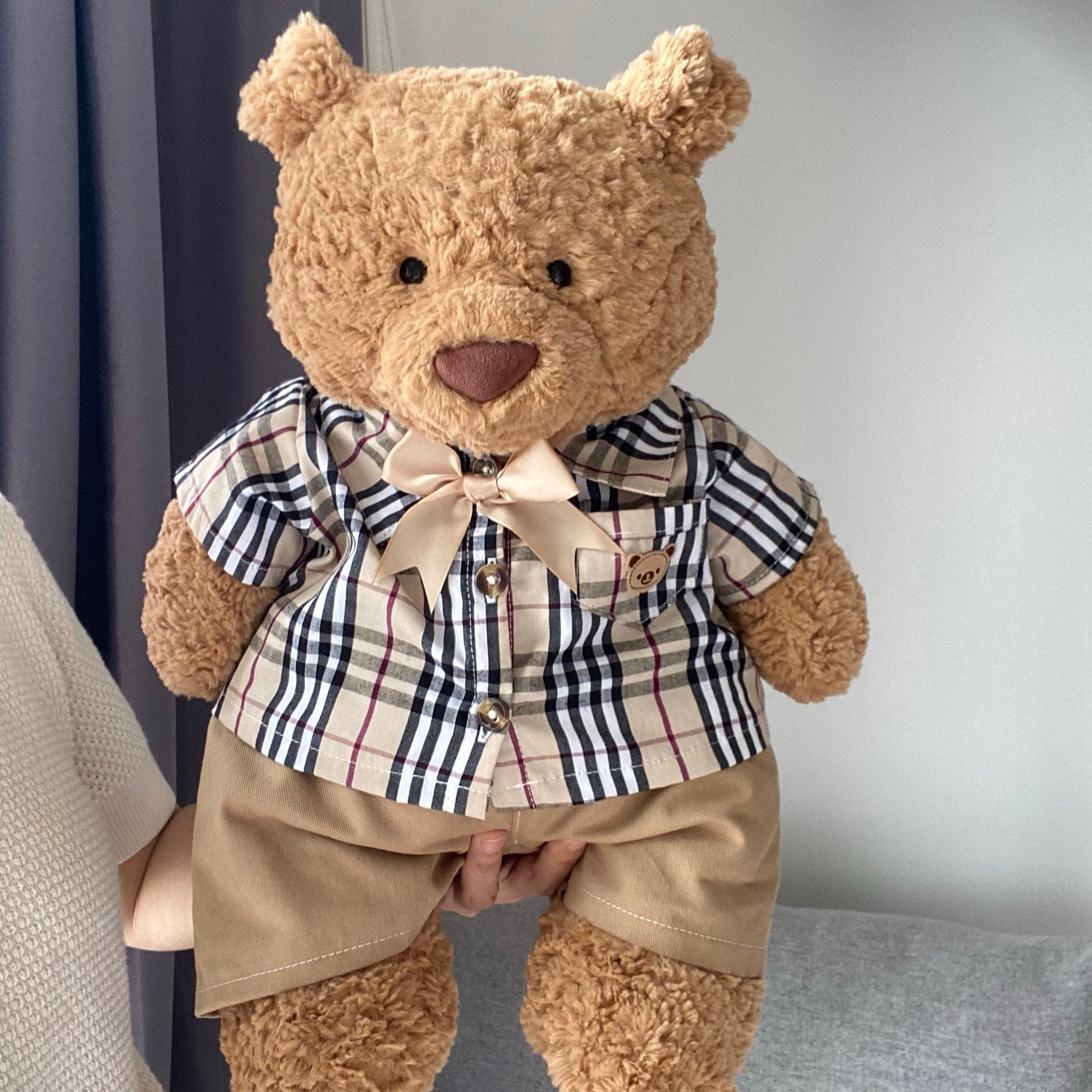 Bartholomew Bear wearing heritage check shirt with bow tie and khaki shorts front view