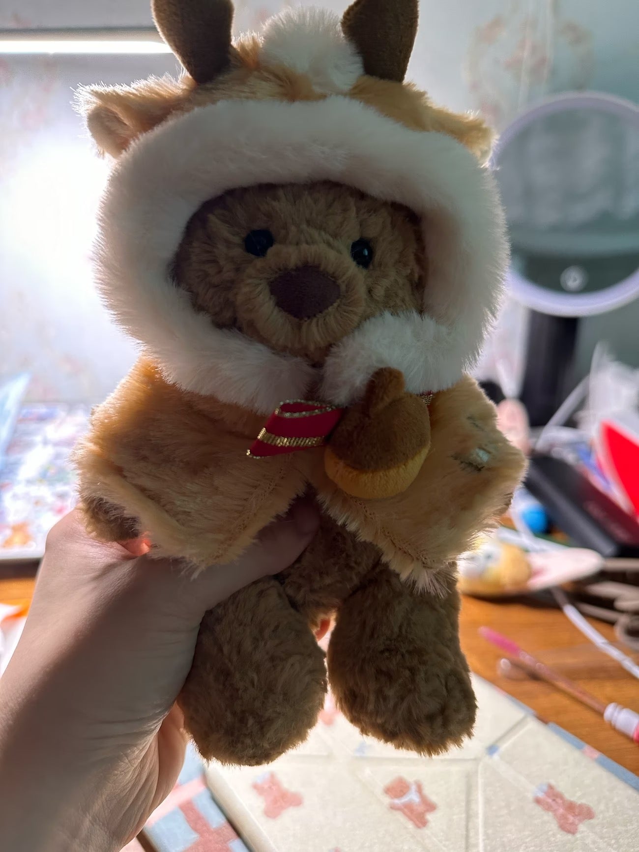 Bartholomew Bear wearing caramel reindeer cape with antlers and red bow front view