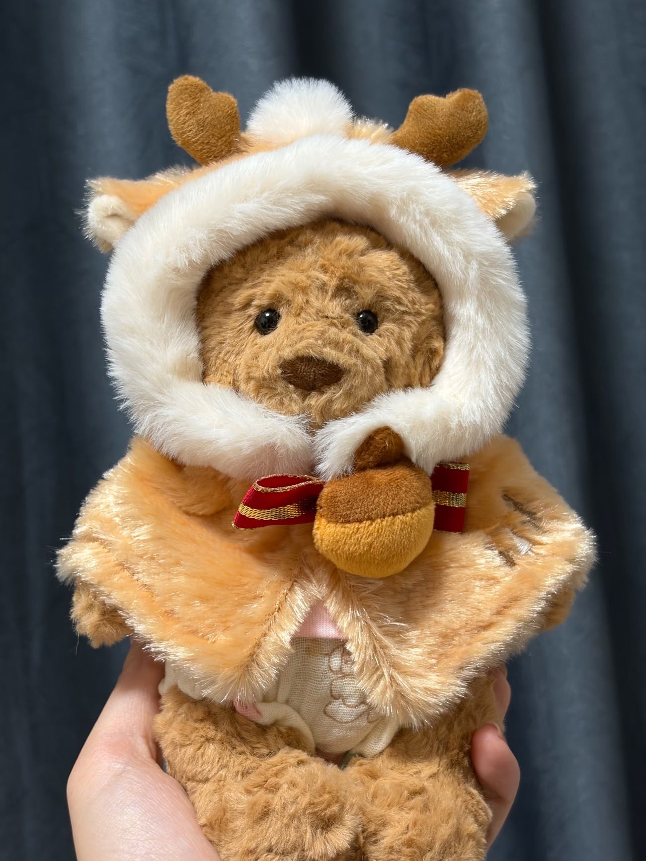 Bartholomew Bear wearing reindeer cape close up with jingle bell detail