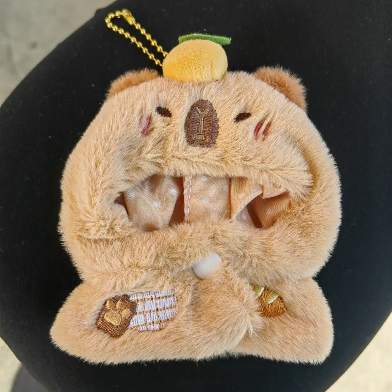 Capybara yuzu plush keychain front view showing embroidered face and paw details