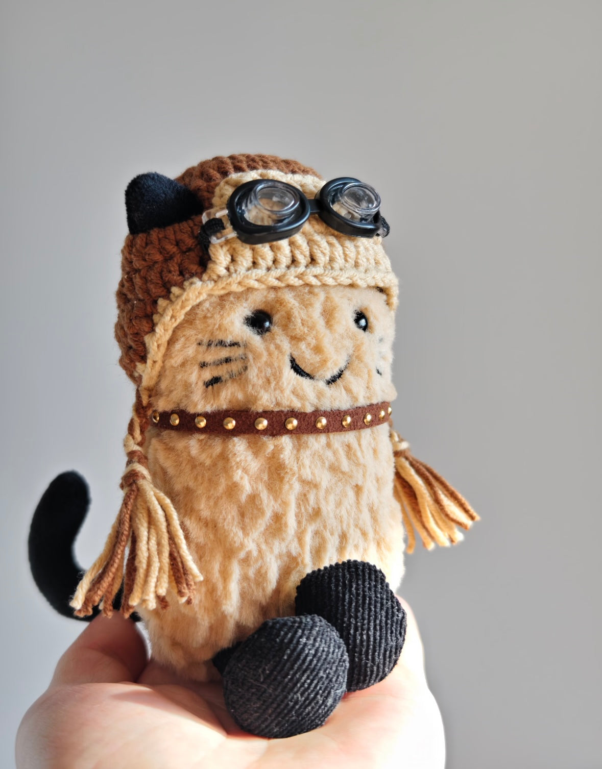 Aviator cat plush wearing full outfit, close-up