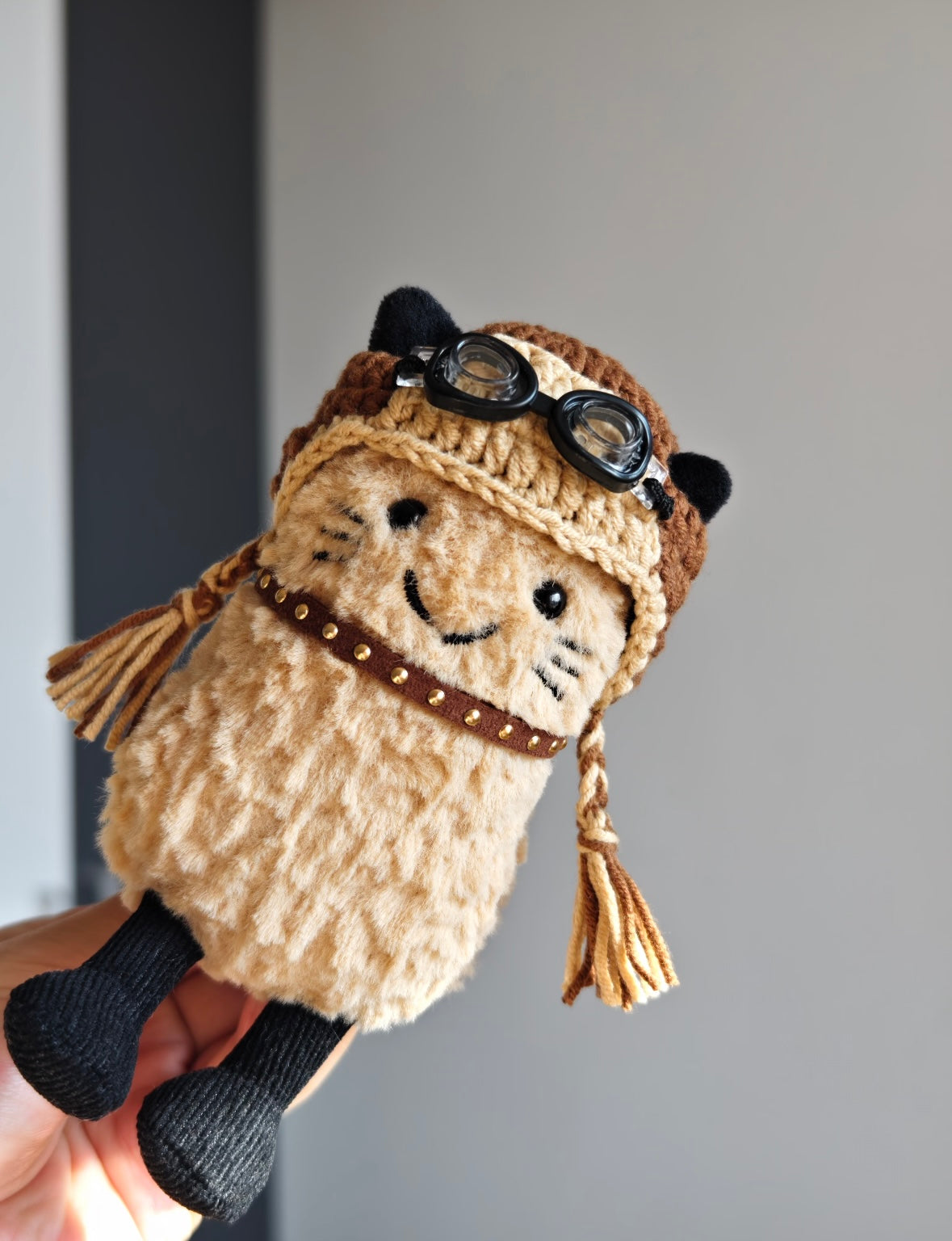 Aviator cat plush wearing helmet, front-facing