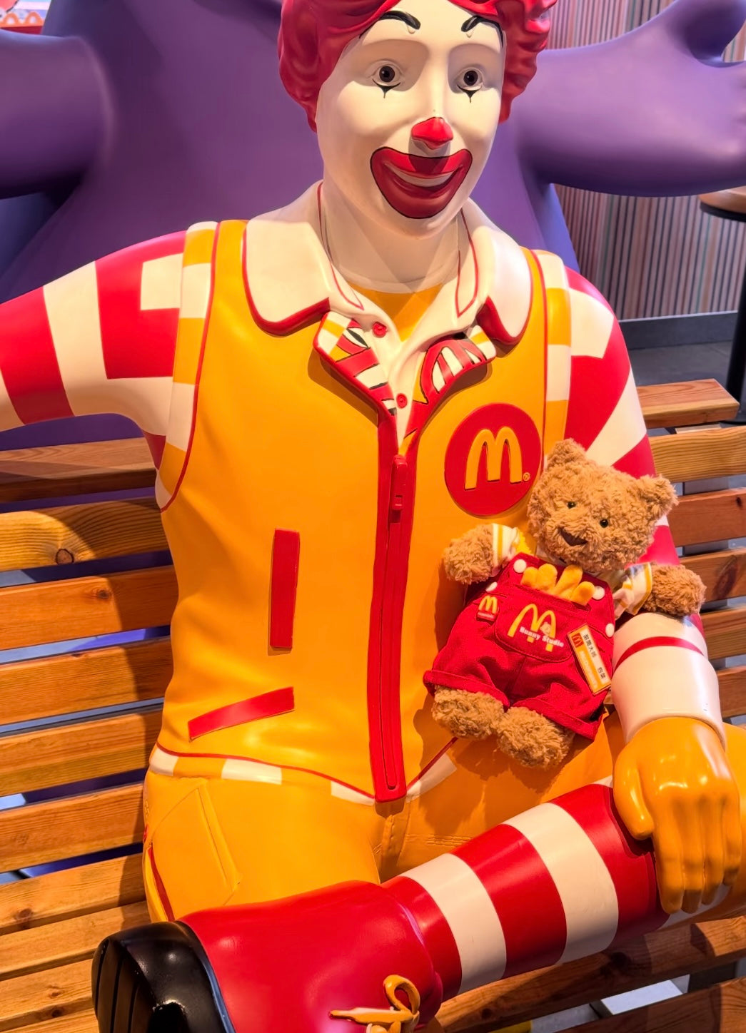 Bartholomew Bear in McDonald's dungaree set sitting with fries and burger on tray