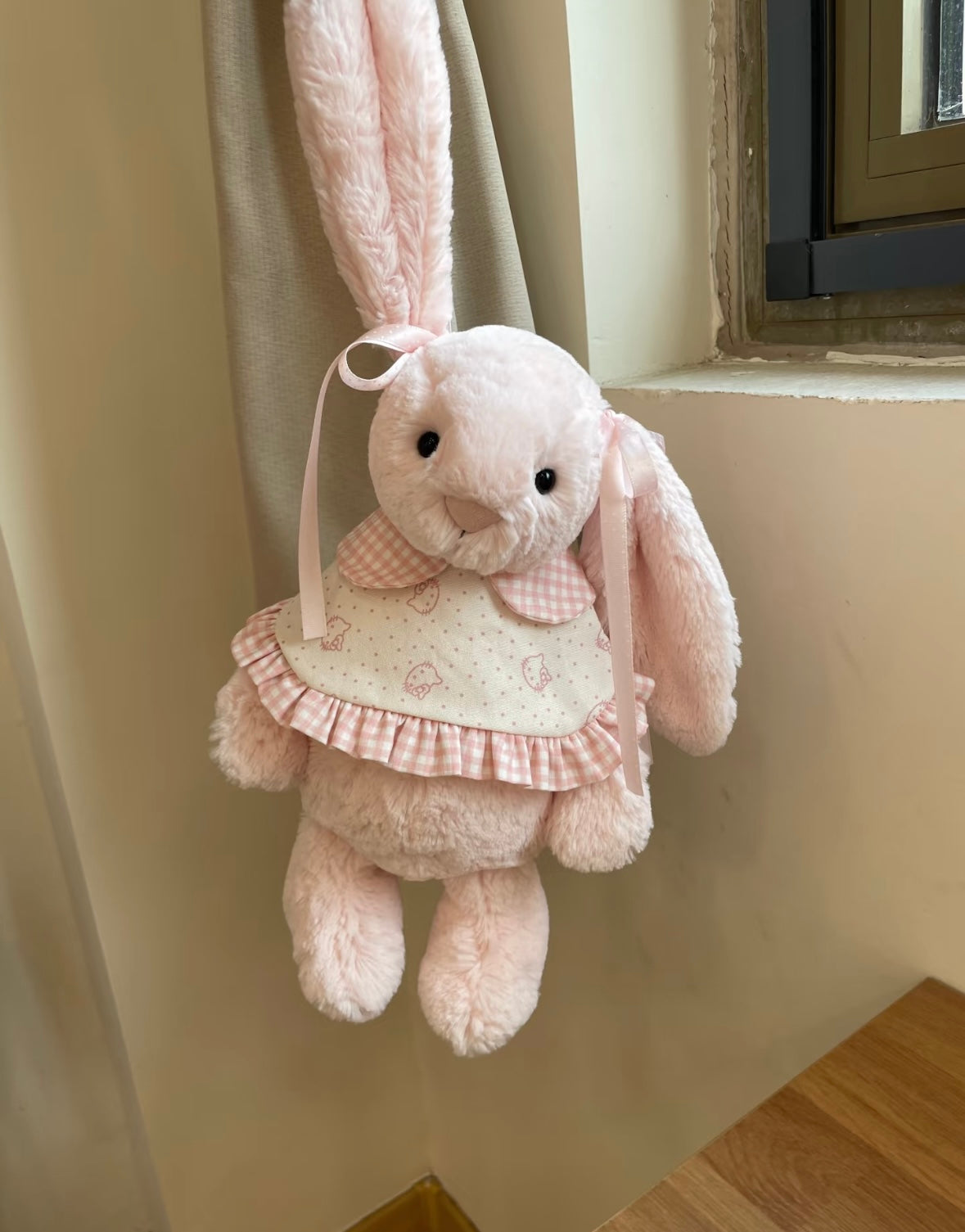 Pink Bashful Bunny wearing pink gingham bunny print dress - hanging view