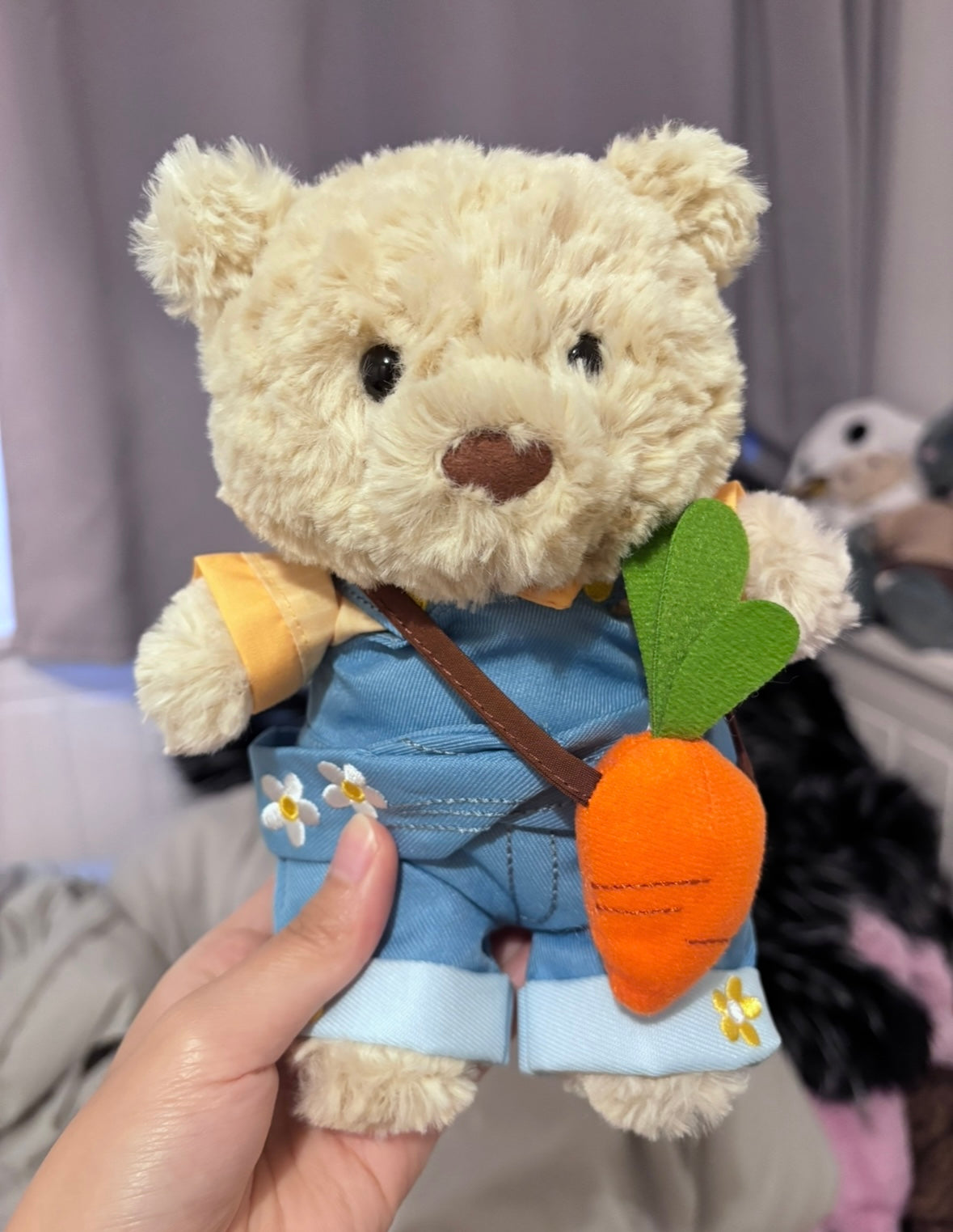 Bartholomew Bear wearing daisy denim dungaree with felt carrot - close up