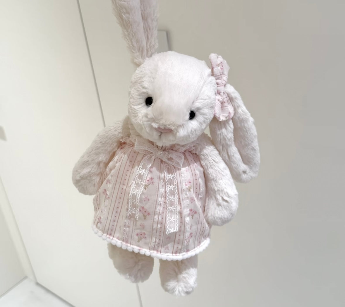 Bashful Bunny wearing vintage lace dress with floral bow - front hanging view