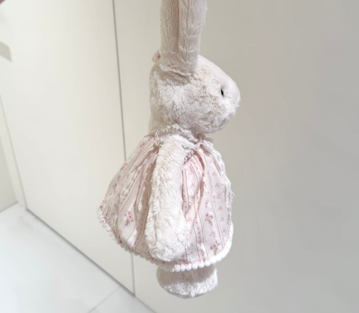 Bashful Bunny vintage lace dress - back hanging view showing lace hem and pom-pom trim