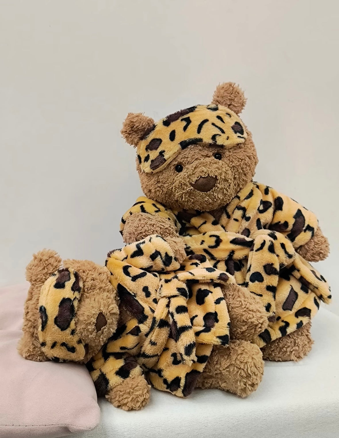 Large Bartholomew Bear wearing leopard print robe with sleep mask pushed up - front view