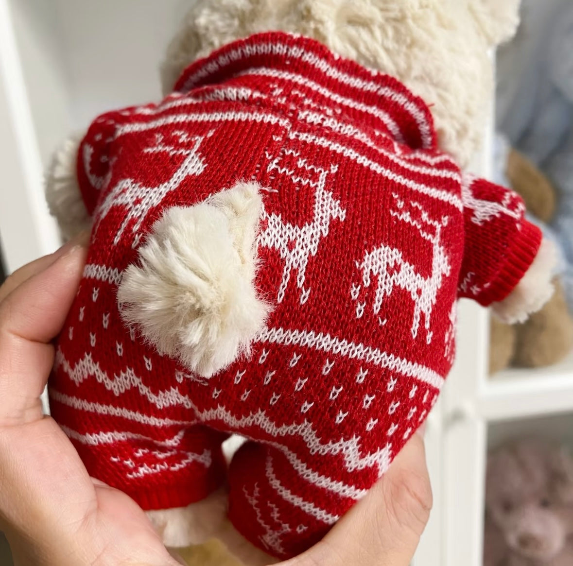 White bear in red Christmas romper, three-quarter view