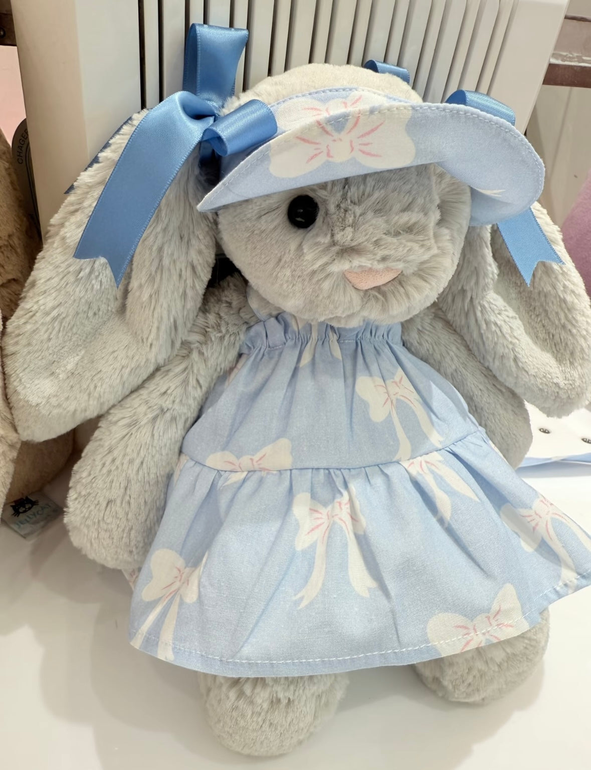 Front view of Bashful Bunny in full blue bow dress set