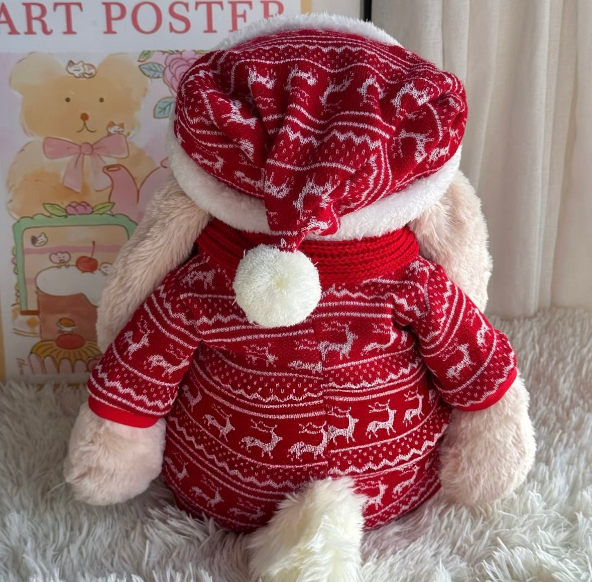 Back view of Bashful Bunny in red reindeer Fair Isle sweater and Santa hat with white pompom detail