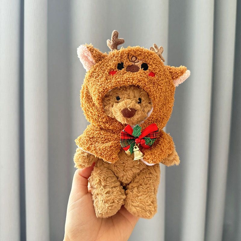 Brown plush bear wearing brown bouclé reindeer hooded cape with antlers, embroidered face and festive plaid jingle bell bow