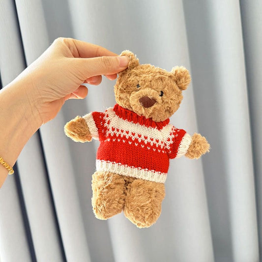 Brown plush bear wearing red and white knitted Christmas turtleneck jumper with heart motif yoke panel