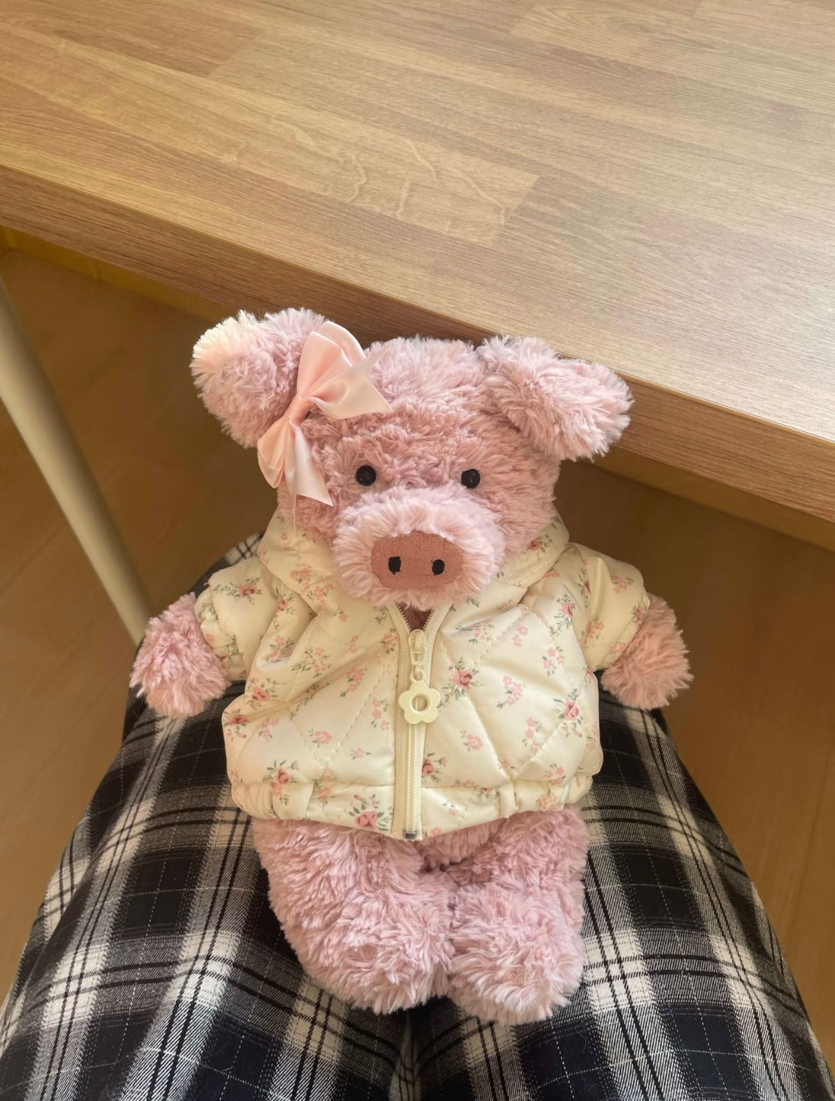 Pink pig plush wearing cream floral puffer jacket